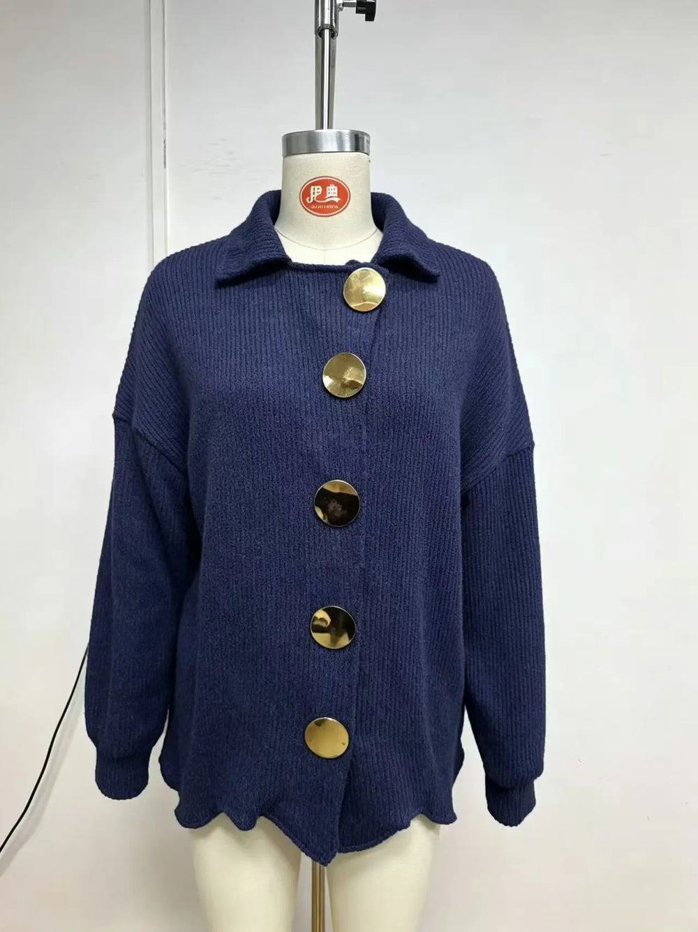 Blue cardigan photographed on a mannequin, front view